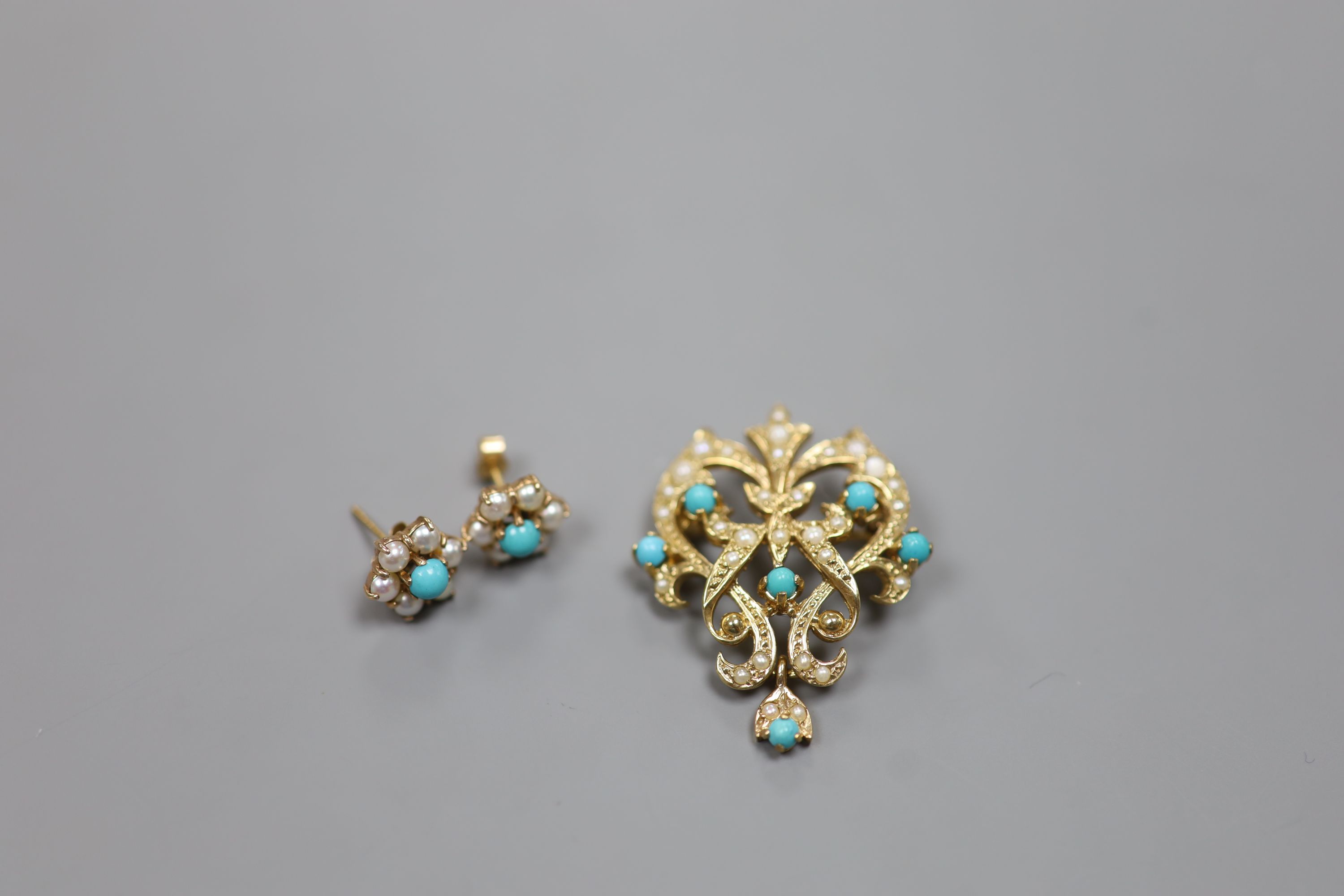 A modern 9ct gold, seed pearl and turquoise set scrolling pendant brooch, 34mm and a pair of matching ear studs